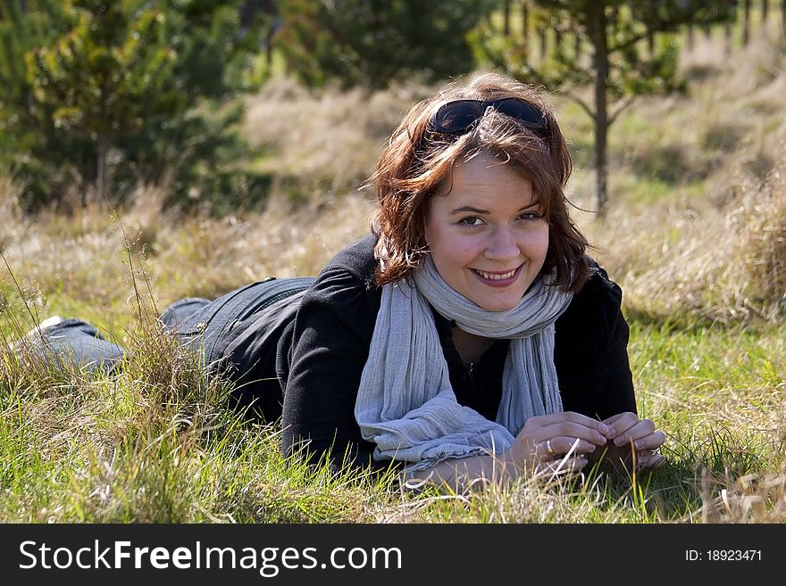 Image of a young woman laying on grass. Image of a young woman laying on grass