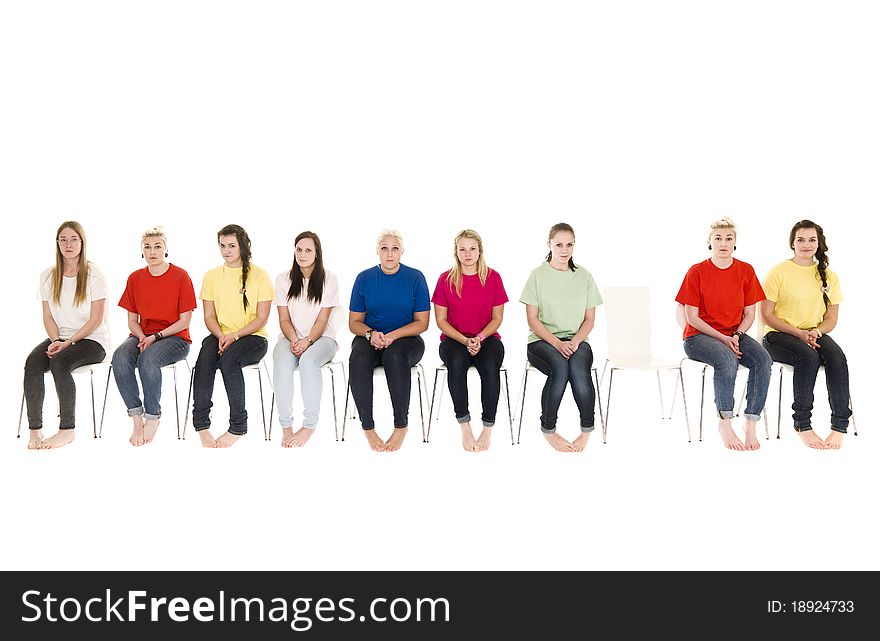 Group of women sitting on chairs and one empty chair. Group of women sitting on chairs and one empty chair