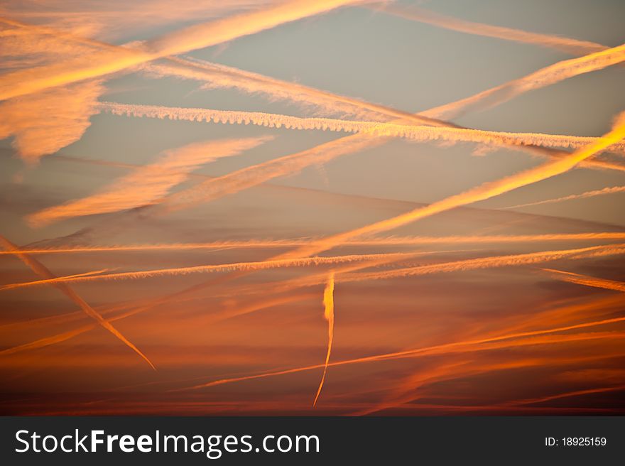 Air traffic at red evening sky