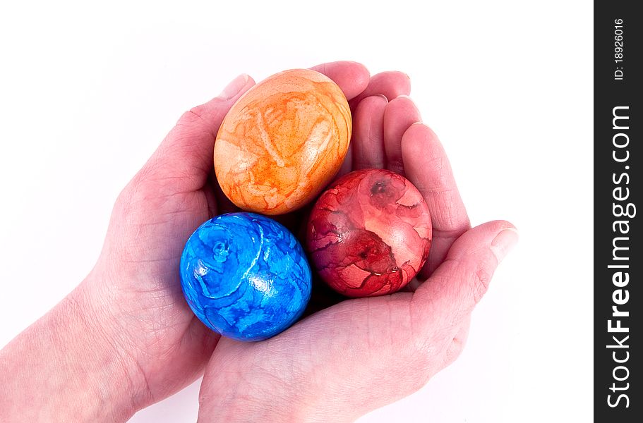 Girls hands holding painted eggs.