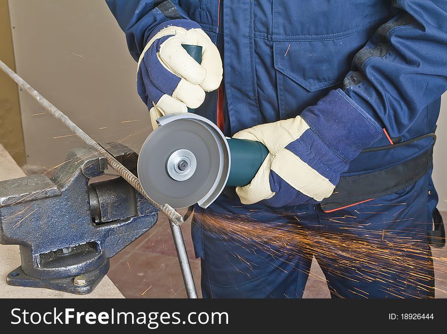 A man working with grinder, close up on tool, hands and sparks, real situation picture. A man working with grinder, close up on tool, hands and sparks, real situation picture