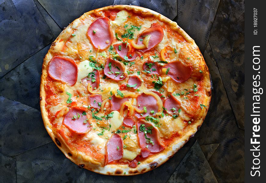 Appetizing pizza with bacon and pepper on stone