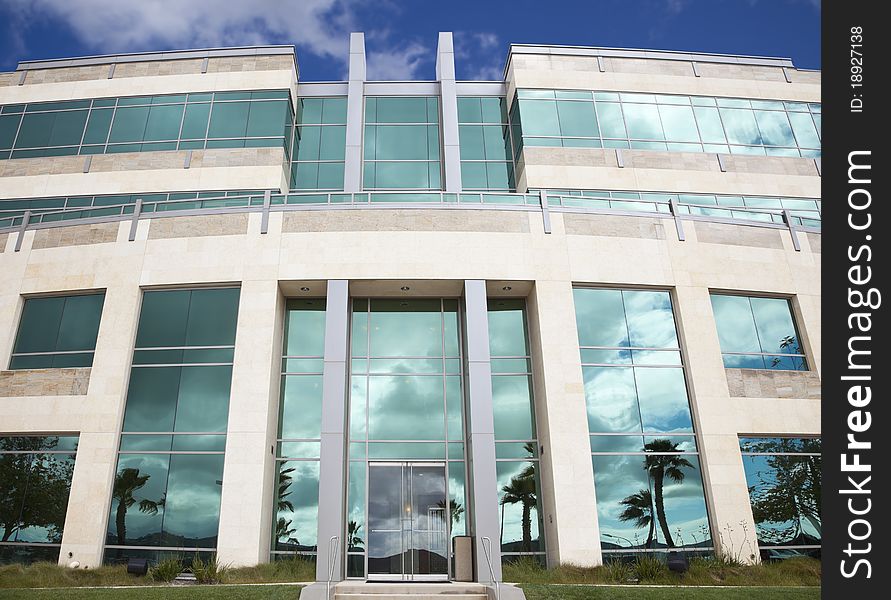 Dramatic Corporate Building with Blue Sky and Clouds.