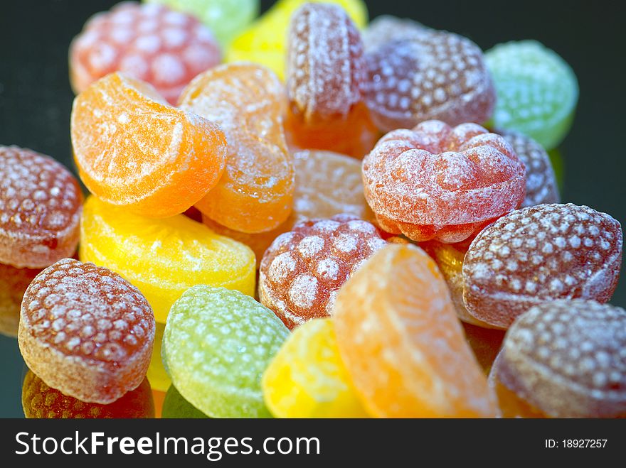 Close up of Colorful caramels with reflected background