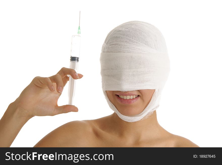 Woman with her head in bandages holding syringe isolated on white