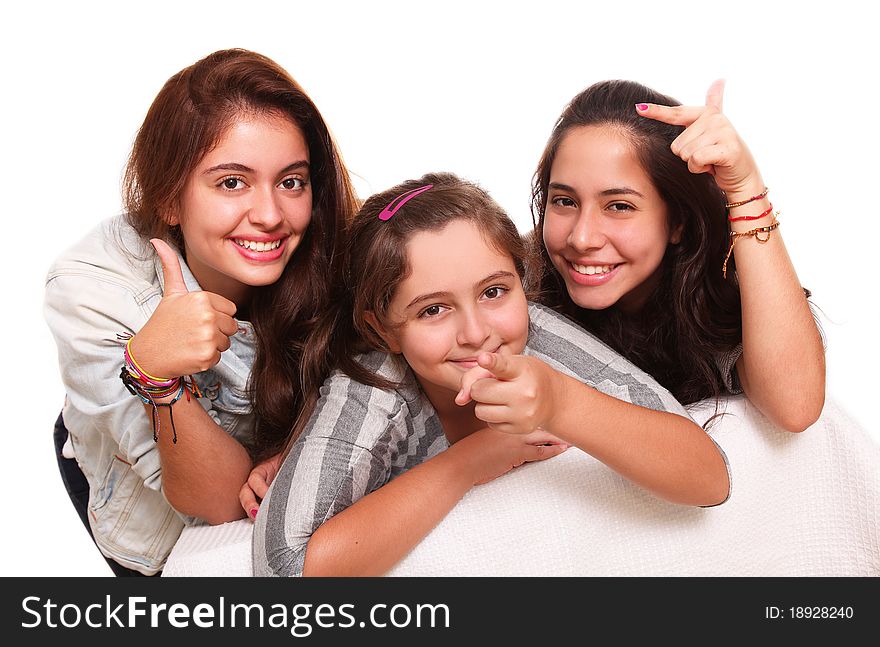 Three beautiful teenagers pointing their hands to different places