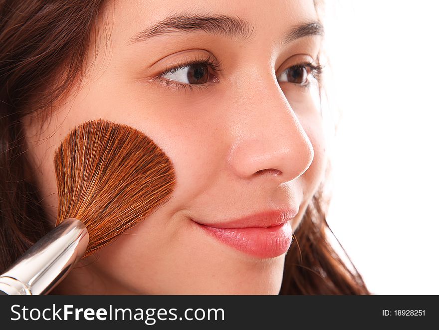 Beautiful woman applying blush on her face