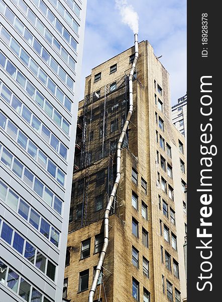 A chimney going up plenty of floors to release its smoke