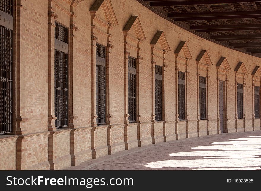 Curved brick facade perspective in historical building in Sevilla. Curved brick facade perspective in historical building in Sevilla