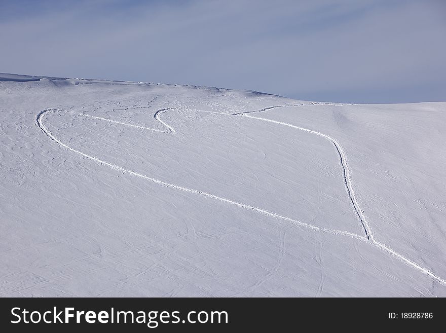 Heart shaped trails in a snow slope