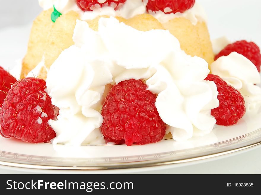 Raspberry dessert with light cream on the white closeup. Raspberry dessert with light cream on the white closeup.