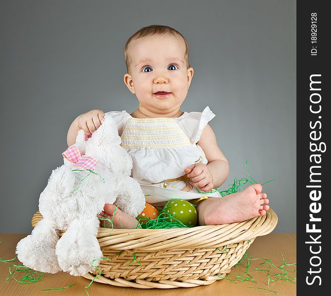 Young babay girl sitting and playing with easter egg. Very cute baby. Young babay girl sitting and playing with easter egg. Very cute baby.