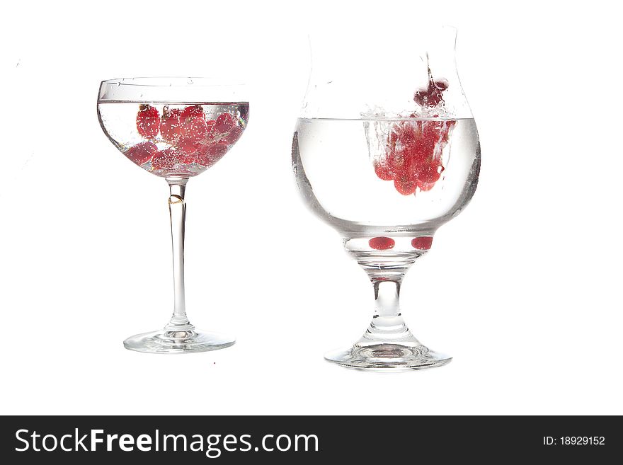 Falling red-berries in a bowl of sparkling water. Falling red-berries in a bowl of sparkling water