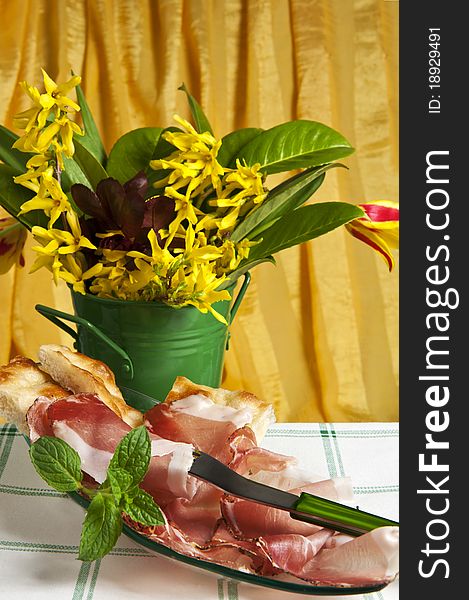 Typical Italian sausage sliced â€‹â€‹cake and flowers. Typical Italian sausage sliced â€‹â€‹cake and flowers