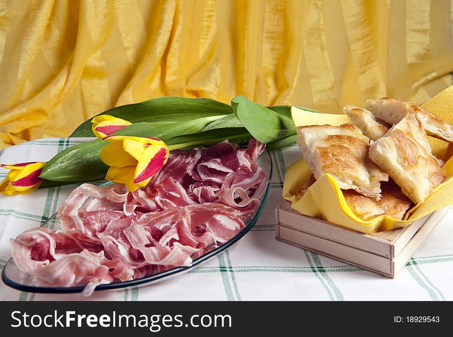 Typical Italian sausage sliced ​​cake and flowers. Typical Italian sausage sliced ​​cake and flowers