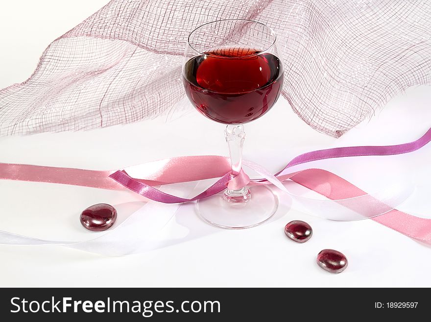 Glass of red wine with ribbons and decorations. Glass of red wine with ribbons and decorations