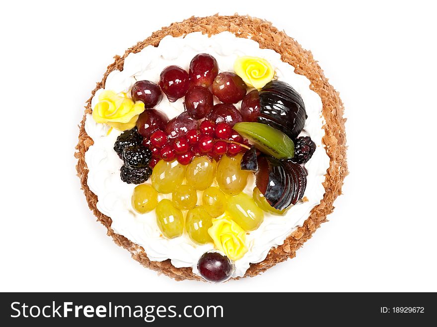 Cake with fruits and whipped cream. Isolated on white