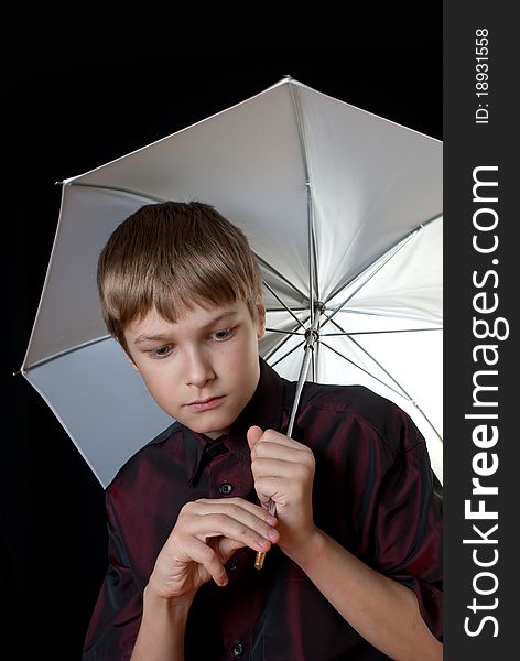Portrait of a young man. In his hands he held a white umbrella.