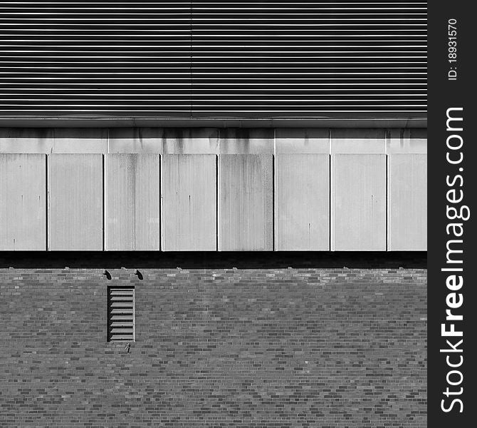 An element (part of the wall) of a modern industrial building, with strong shadows emphasizing the textures. An element (part of the wall) of a modern industrial building, with strong shadows emphasizing the textures.