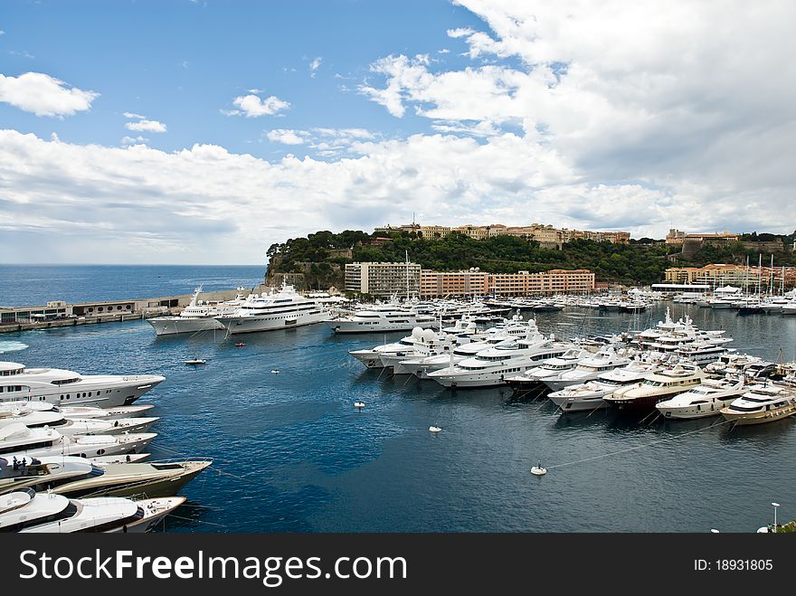 Monaco seaport scenery: harbour,luxury yachts,marina, and palace.