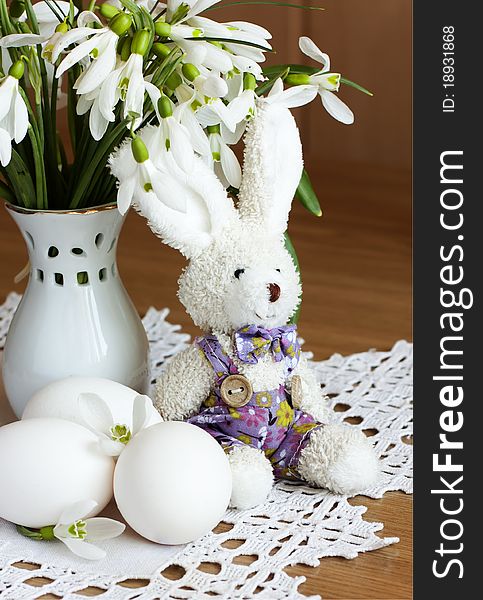 Eggs,toy rabbit and snowdrops