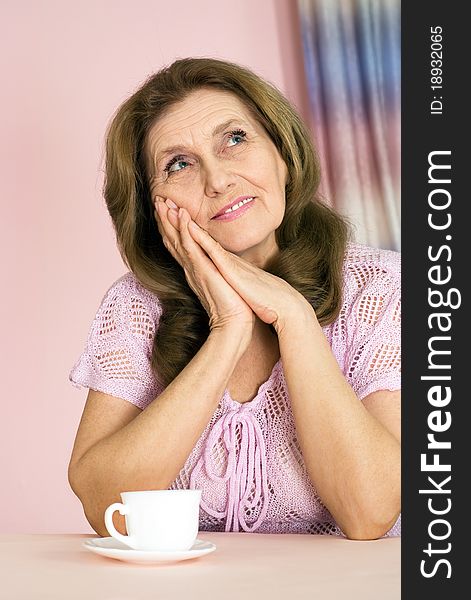 Nice elderly woman on a pink background