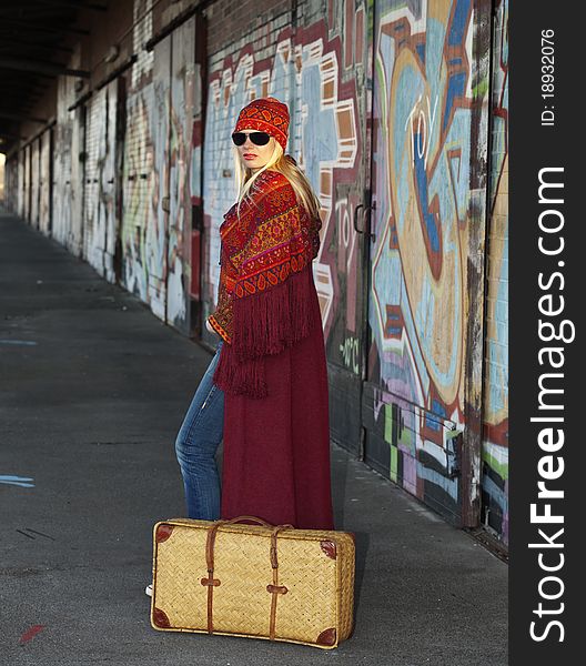 Woman with an old fashioned suitcase Waiting on a very old railroad station platform