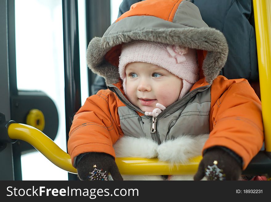 Mother with young baby stay near bus doors preparing to exit from bus