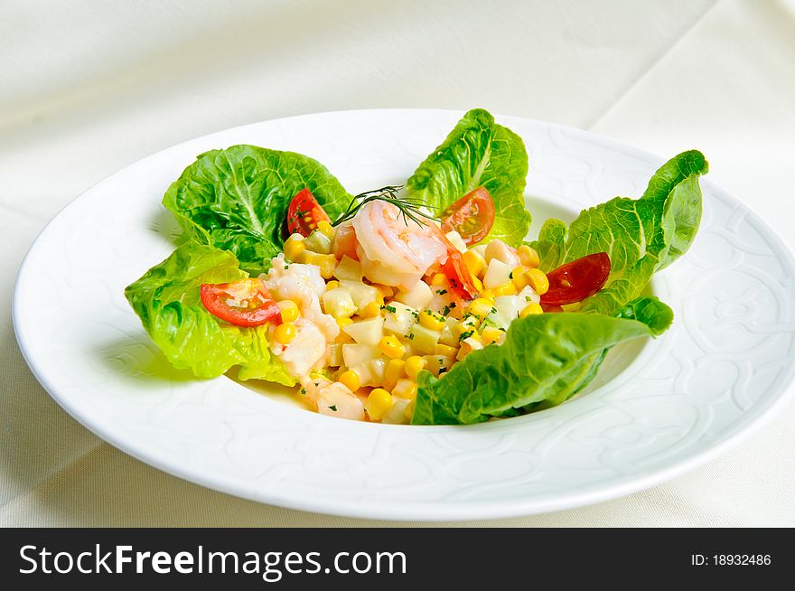 Tasty green salad with prawns and corn