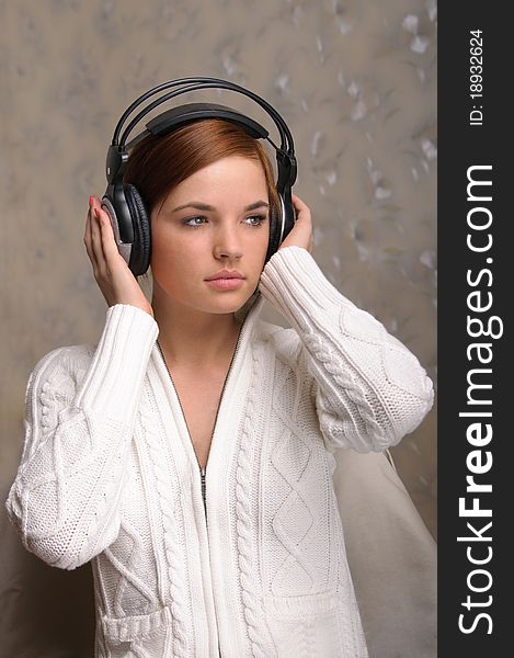 Beautiful young girl listens to her favorite tunes. Beautiful young girl listens to her favorite tunes