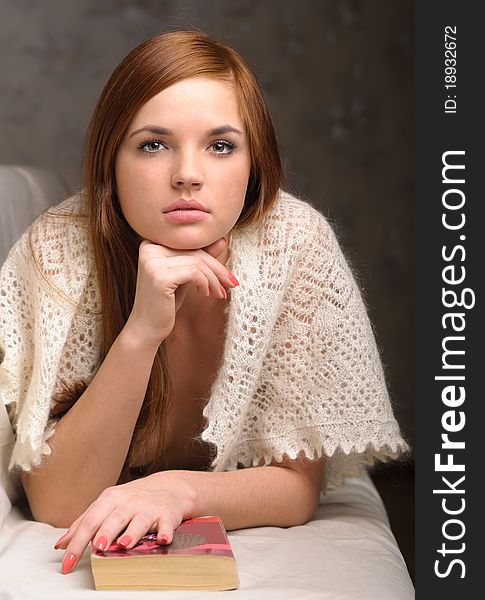 Young woman relaxing on the couch reading a book. Young woman relaxing on the couch reading a book