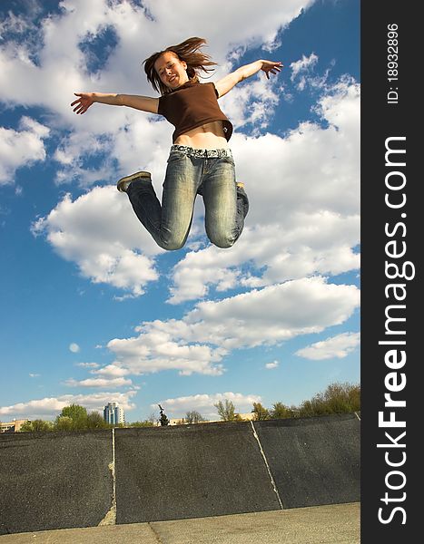 The girl jumps from a fountain.