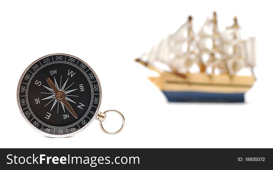 Compass and model classic boat on white background. Compass and model classic boat on white background