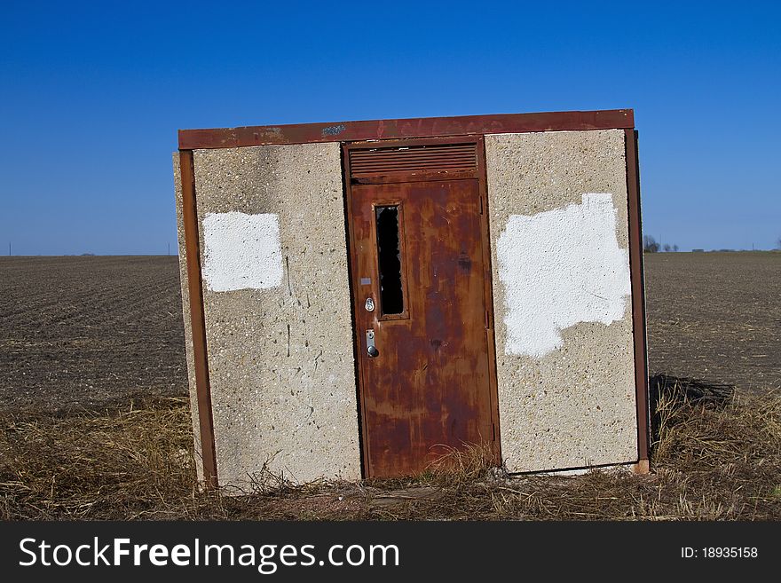 Abandoned pump-house outbuilding on the edge of a field. Abandoned pump-house outbuilding on the edge of a field