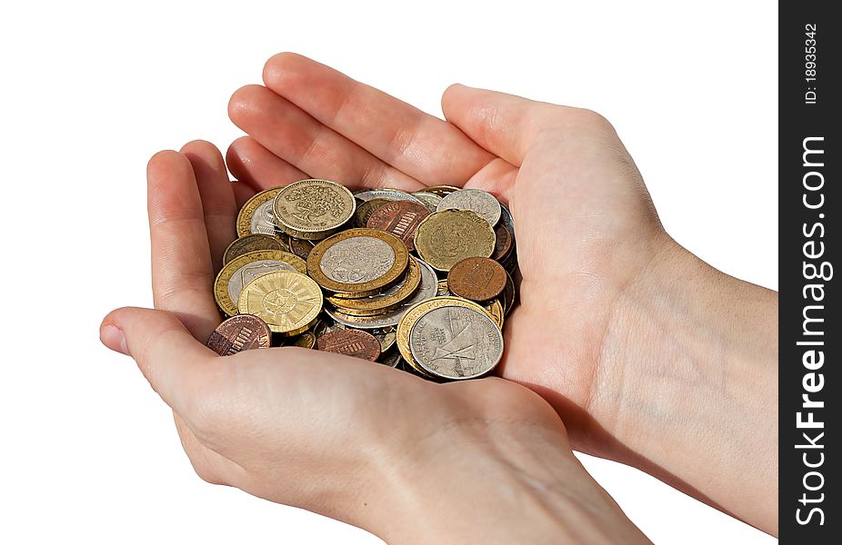 Woman's hands holding a pile of different coins isolated on white background