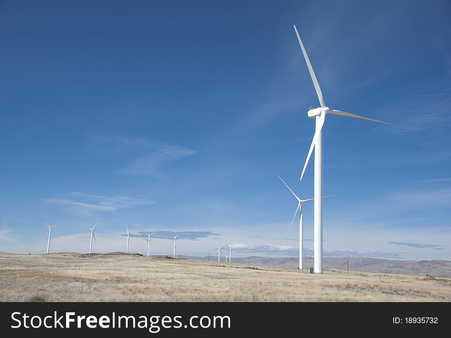 Wind power generators, windmills, in a field in Oregon. Wind power generators, windmills, in a field in Oregon