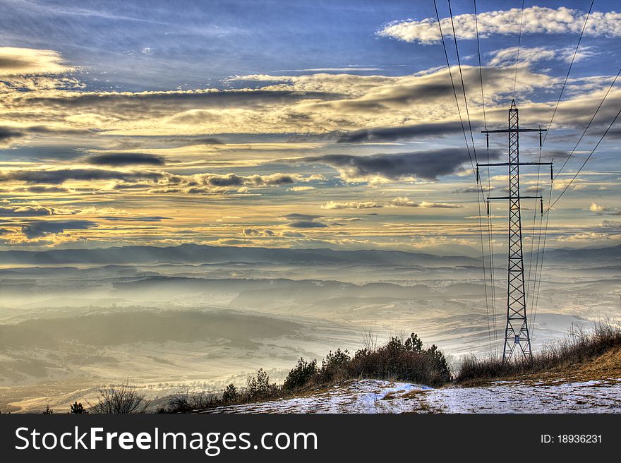 Electrical Pole At Sunset With Mountain Range