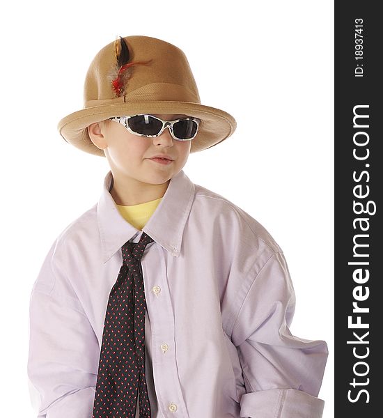 A handsome kindergarten boy with sunglasses, dressing up in Grandpa's shirt, tie and hat. Isolated on white. A handsome kindergarten boy with sunglasses, dressing up in Grandpa's shirt, tie and hat. Isolated on white.