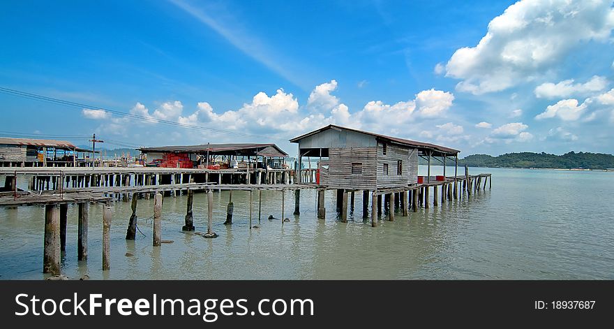 Fishing Village with Blue Cloudy Sky Background