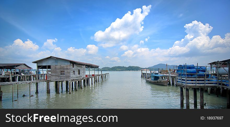 Fishing Village with Blue Cloudy Sky Background