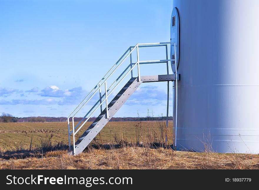 An image of wind turbine against blue sky