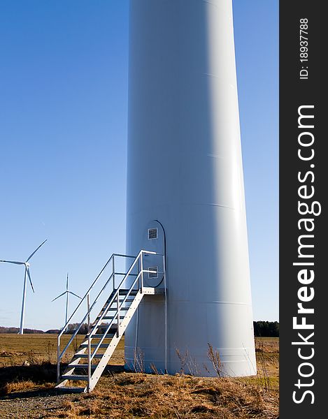 An image of wind turbine against blue sky