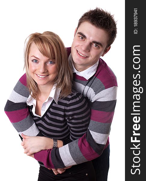 Portrait of a romantic young couple standing together over white background