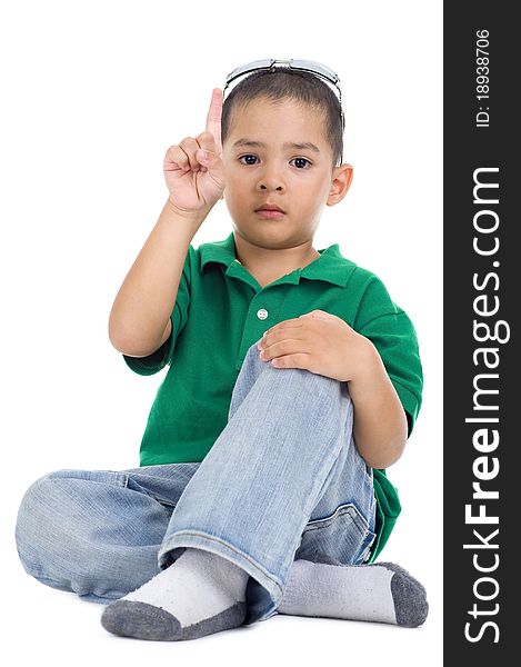 Boy with one finger raised, isolated on white background
