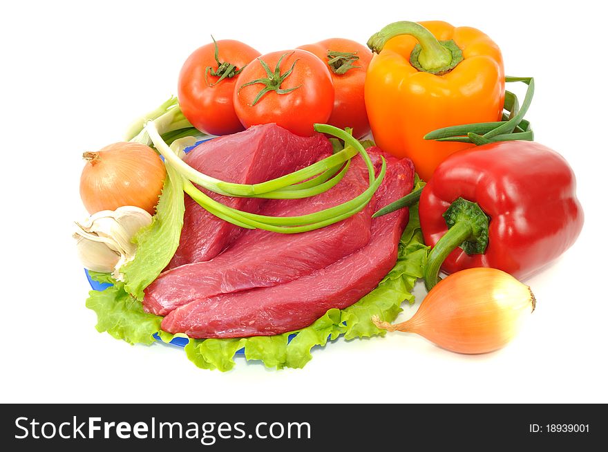 Vegetables and raw beef, isolated on a white background. Vegetables and raw beef, isolated on a white background