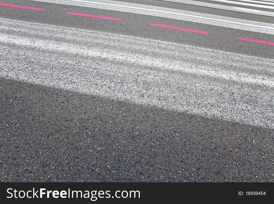 Markings of an airport runway running diagonally through the image. Markings of an airport runway running diagonally through the image