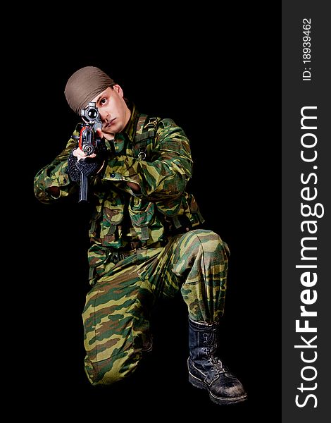 Soldier with weapon, isolated on black background