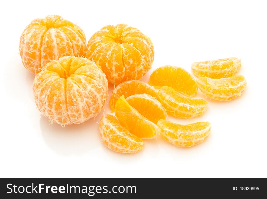 Lices of peeled orange on white background