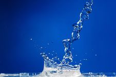 Splash On A Blue Background Stock Images