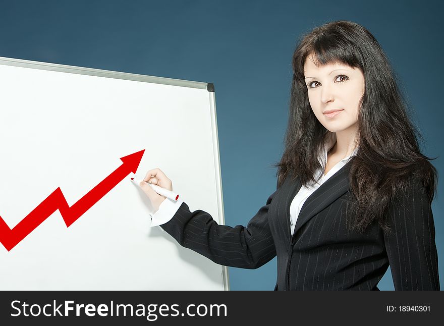 Young businesswoman drawing graph on a board